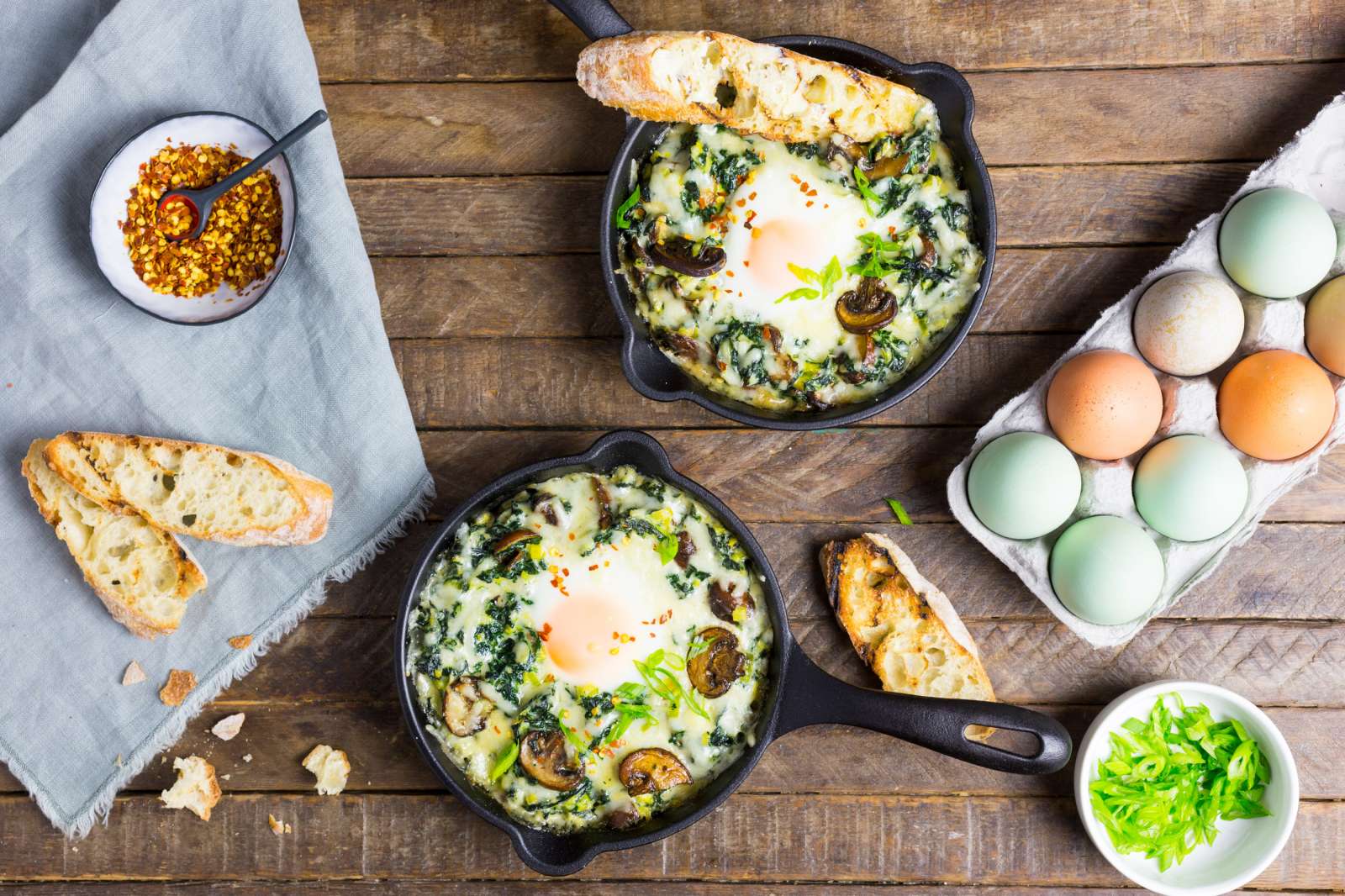 Baked Eggs with Creamy Greens and Garlic Butter Toasts